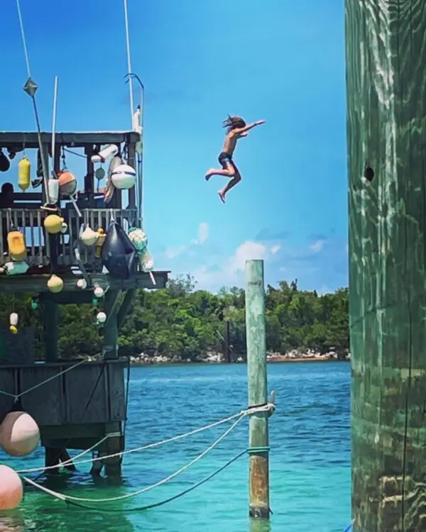 A person jumping in the air over water.